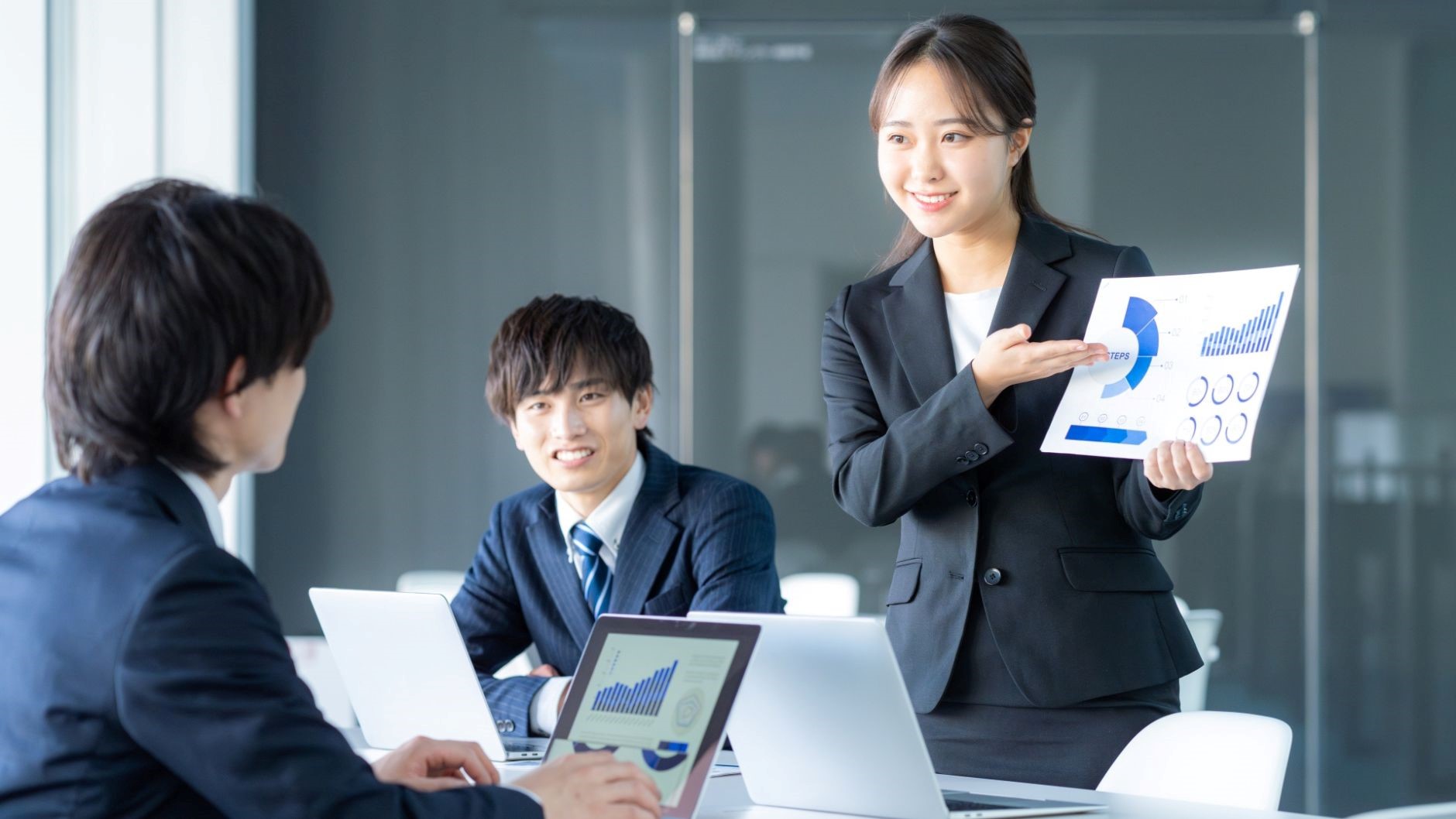 女性が紙をもってプレゼンテーション